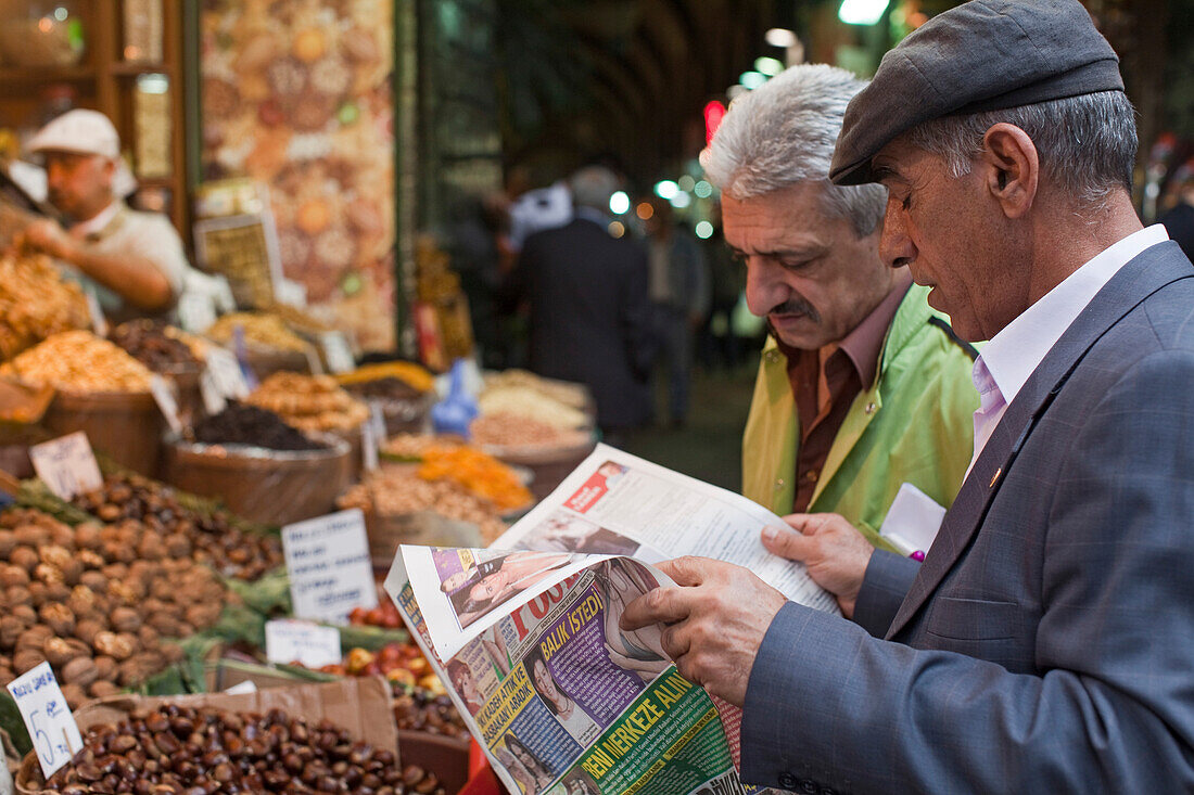 Turkish men with newspaper in Egyptian Bazaar, Istanbul, Turkey