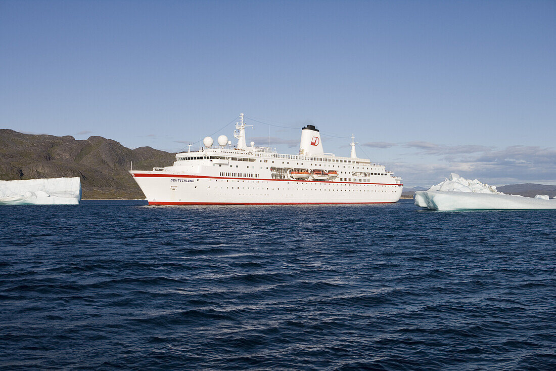 Cruise ship MS Deutschland and icebergs in the sunlight, Kitaa, Greenland