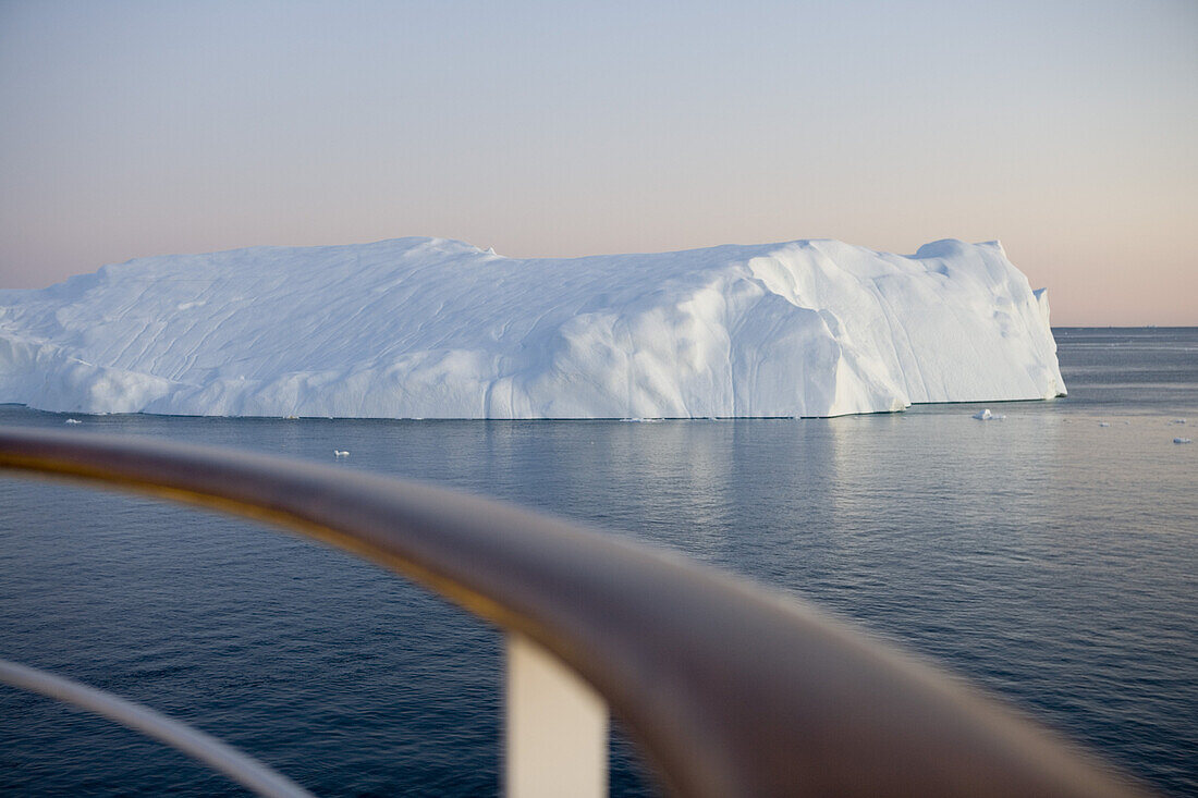 Railing of cruise ship MS Deutschland and icebergs from Ilulissat Kangerlua Icefjord at dusk, Ilulissat (Jakobshavn), Disko Bay, Kitaa, Greenland