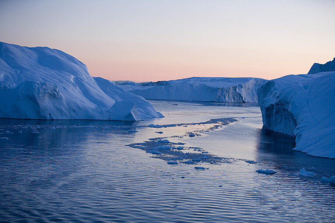 View at icebergs from Ilulissat Kangerlua Icefjord at dusk, Ilulissat (Jakobshavn), Disko Bay, Kitaa, Greenland