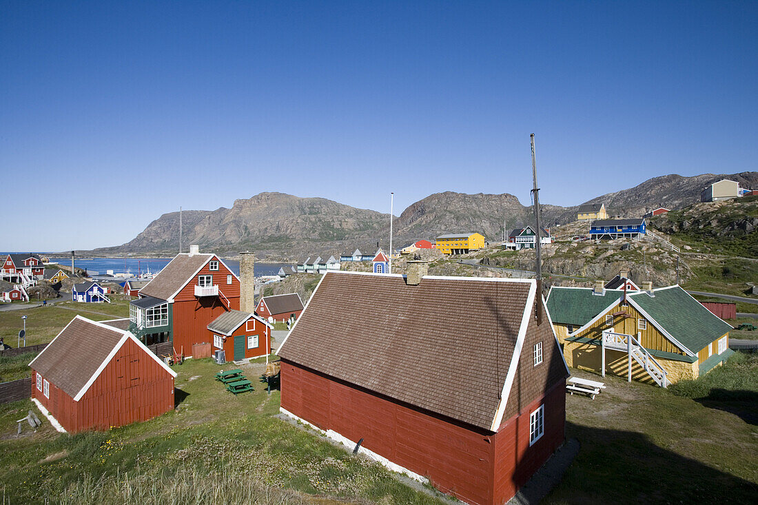 Wooden houses on the waterfront under blue sky, Sisimiut, Kitaa, Greenland