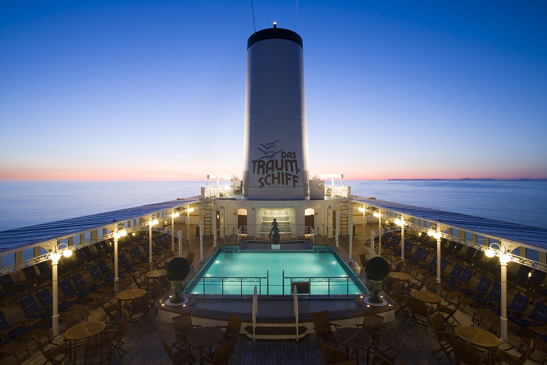 Illuminated pool on cruise ship MS Deutschland in the evening, Atlantic ocean