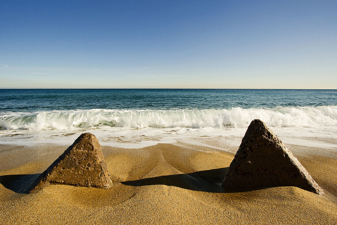 2 pyramidal stones in the seaside