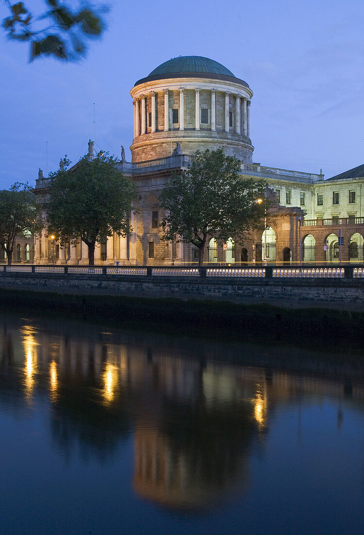 Ireland,  Dublin,  James Gandon´s Four Courts reflects in the River Liffey at dawn