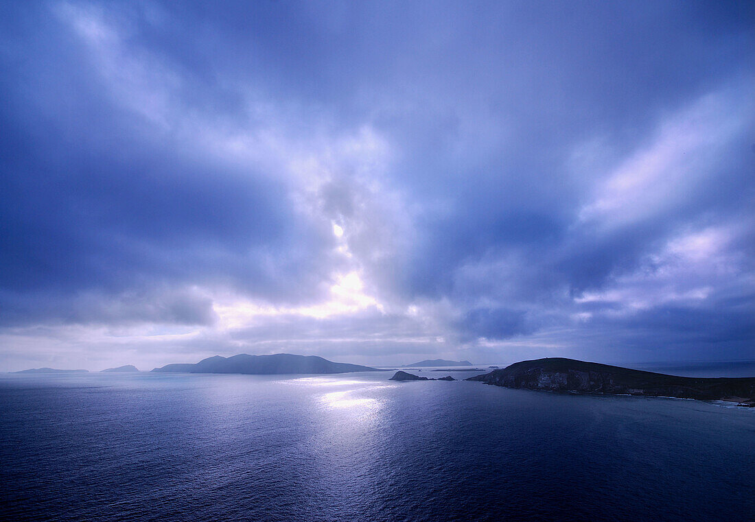 the sun setting behind the blasket islands in slea head near dingle in kerry in the west of ireland, the most westerly point in europe