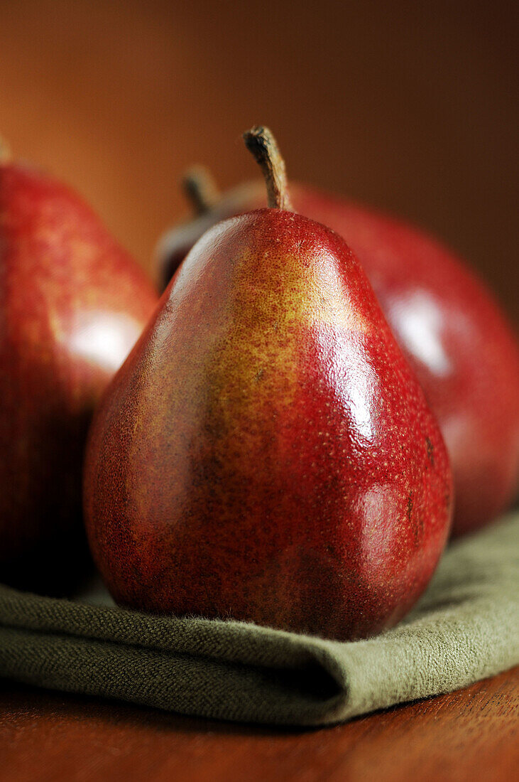 Red Anjou pears on green cloth