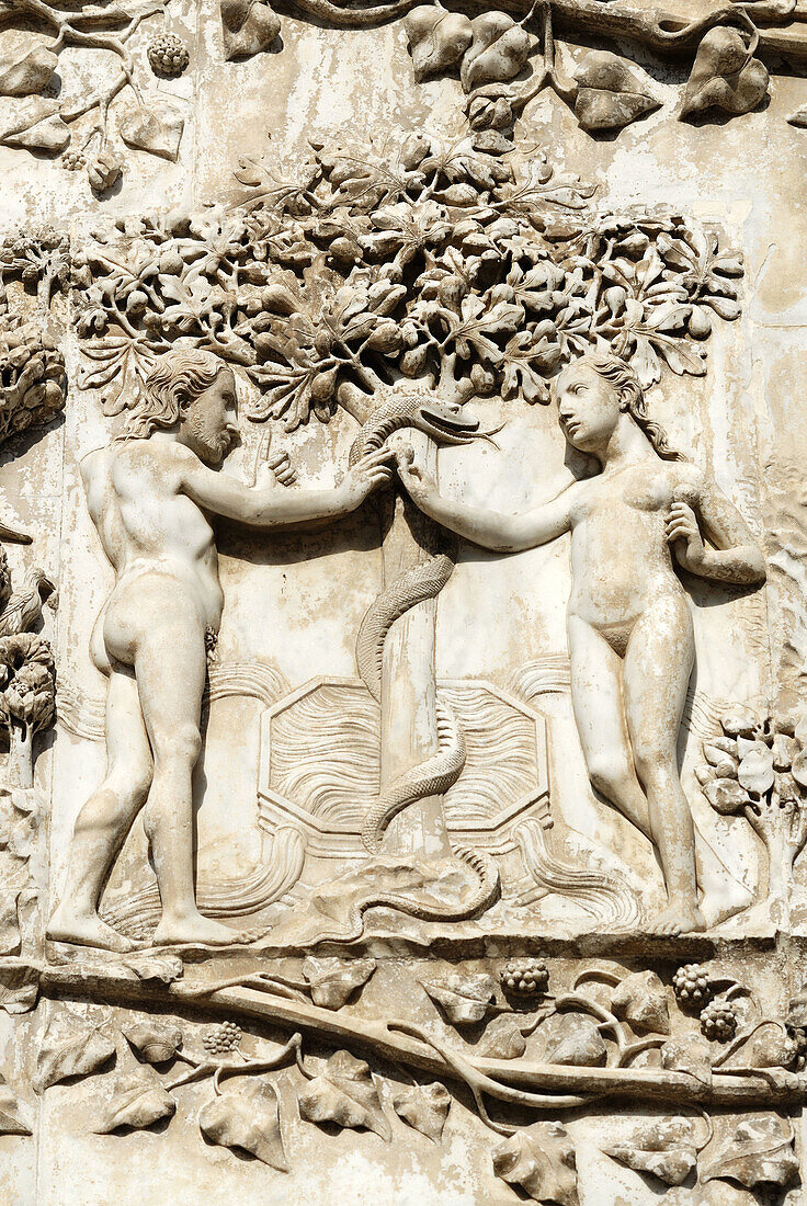 Orvieto Umbria Italy Detail of marble bas-reliefs on the facade of the Duomo Marble bas reliefs c 1320 - 1330 ascribed to Maitani & assistants depicting Adam and Eve tempted by the Serpent