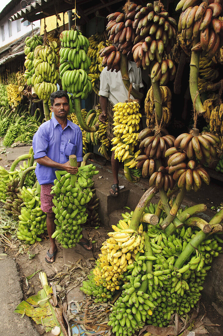 A man working at a banana shop  Kollam,  Kerala,  India
