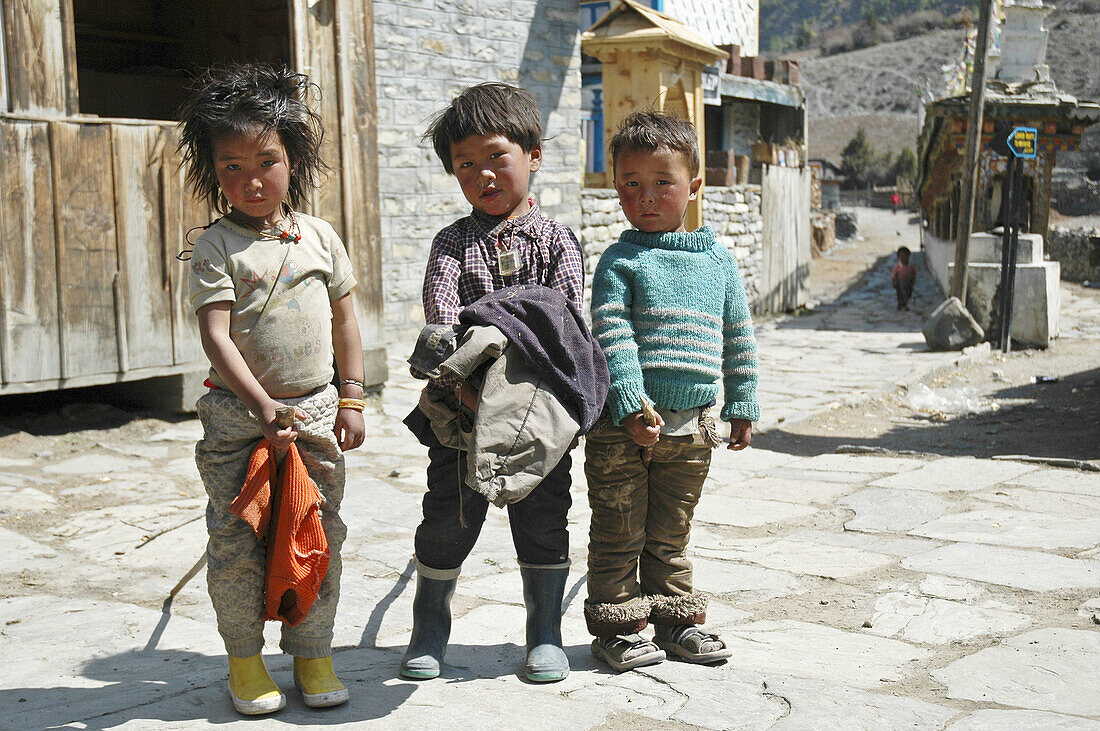 Children riding stick horses  Chame,  Nepal