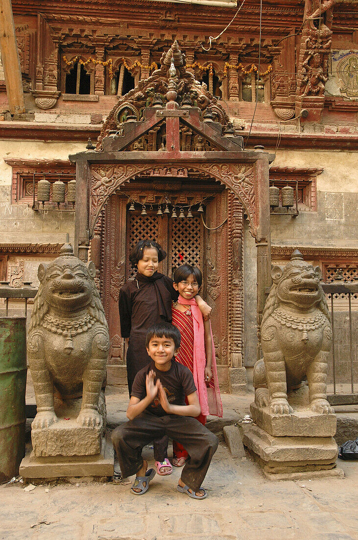 Children posing in front of a temple door  Kathmandu,  Nepal