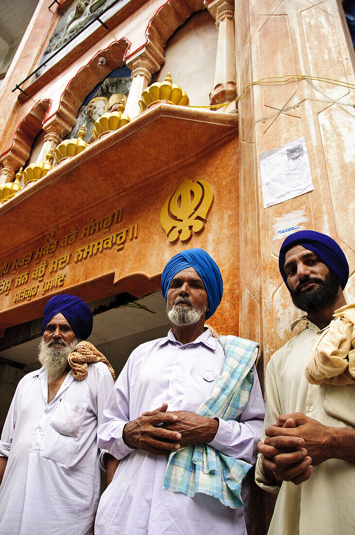 Sikh men standing in front of Gurdwara Shri Guru Nanak Dev Ji Manikaren,  Himachal Pradesh,  India