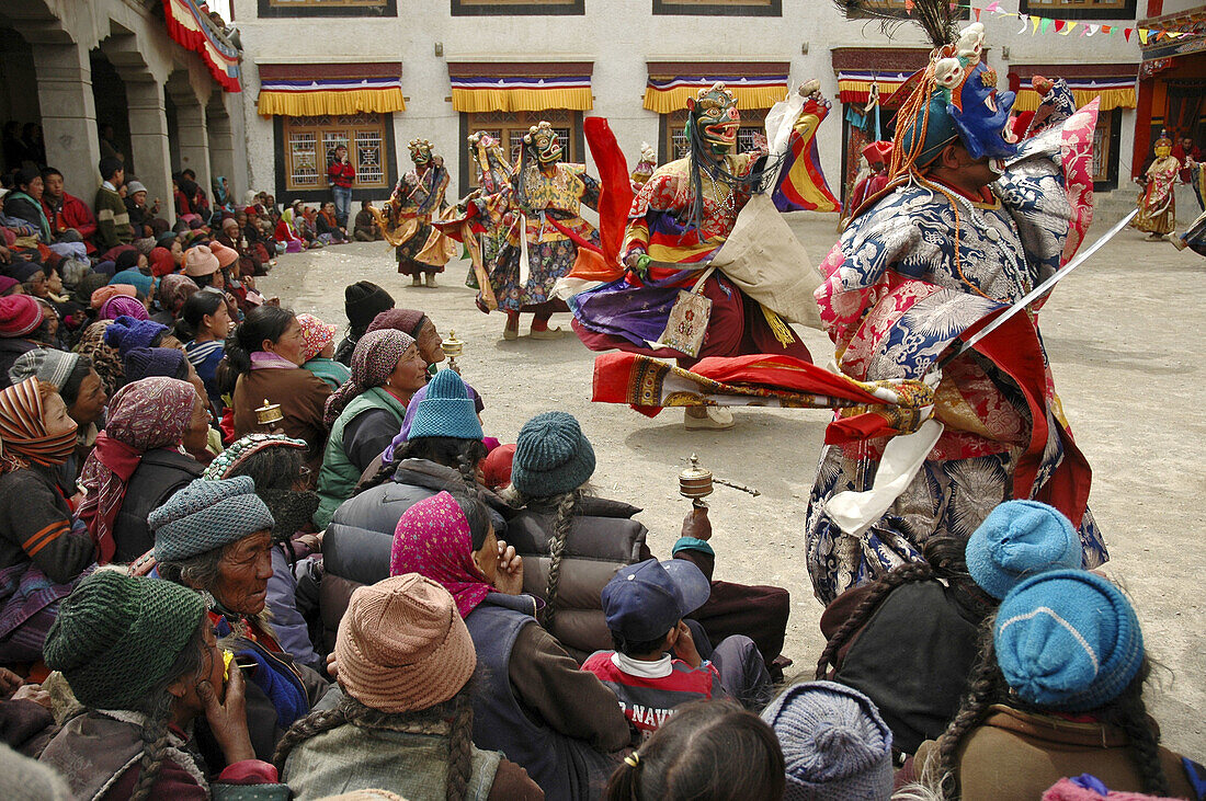 Masked monks dancing for a crowd of spectators Lama Yuru,  Ladakh,  India