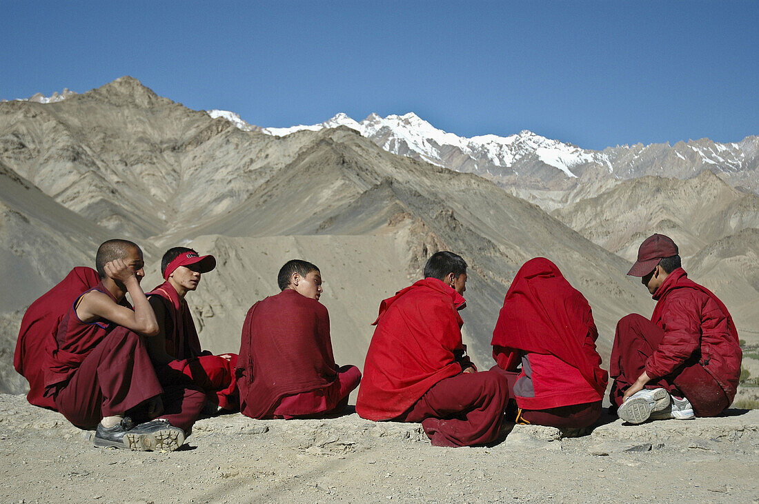A group of novice monks sitting outside of the monastery Lama Yuru,  Ladakh,  India