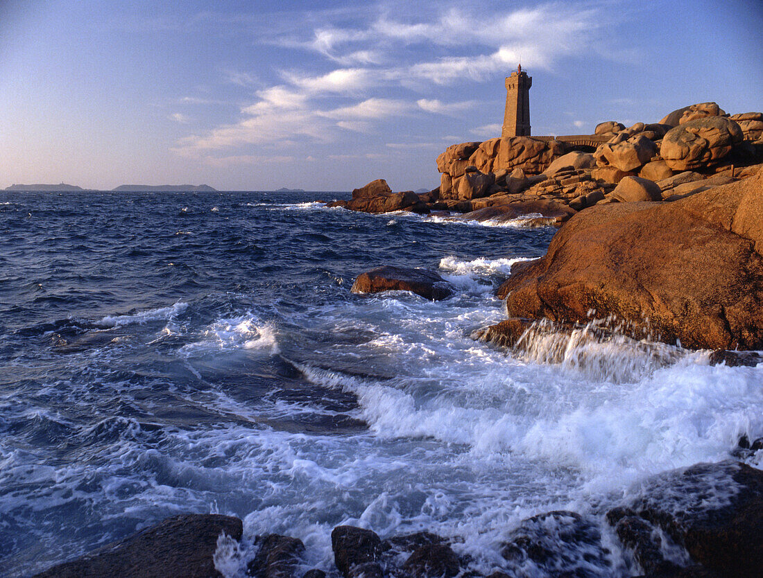 Lighthouse on the waterfront in the light of the evening sun, Cote de Granit Rosé,  Brittany, France, Europe