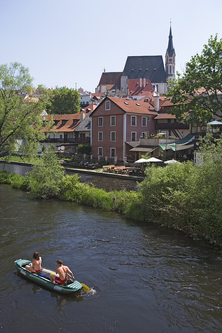 Canoeing on the Vltava river with the old town and the church of St. Veit in the back, Cesky Krumlov, South Bohemian Region, Czech Republic