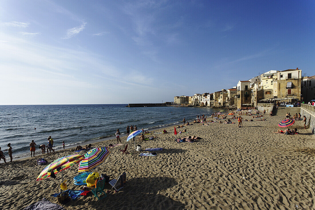 View along beach to Cefalu, Sicily, Italy
