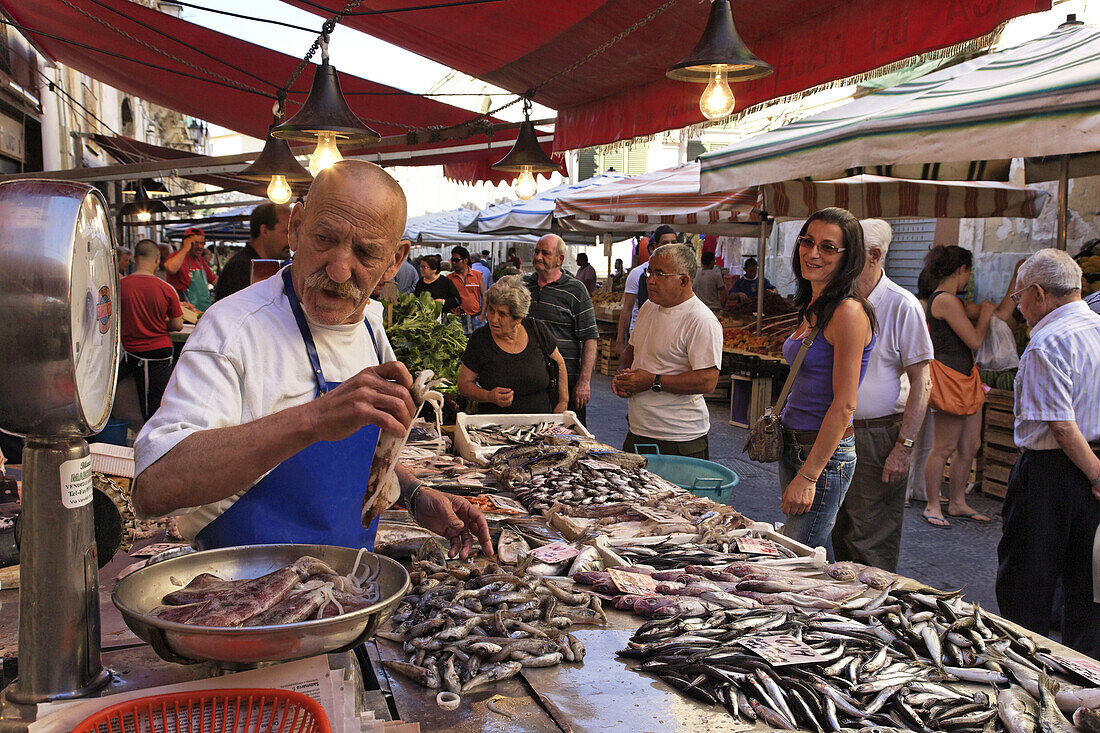 Fishmonger at market, Syracuse, Ortygia island, Sicily, Italy