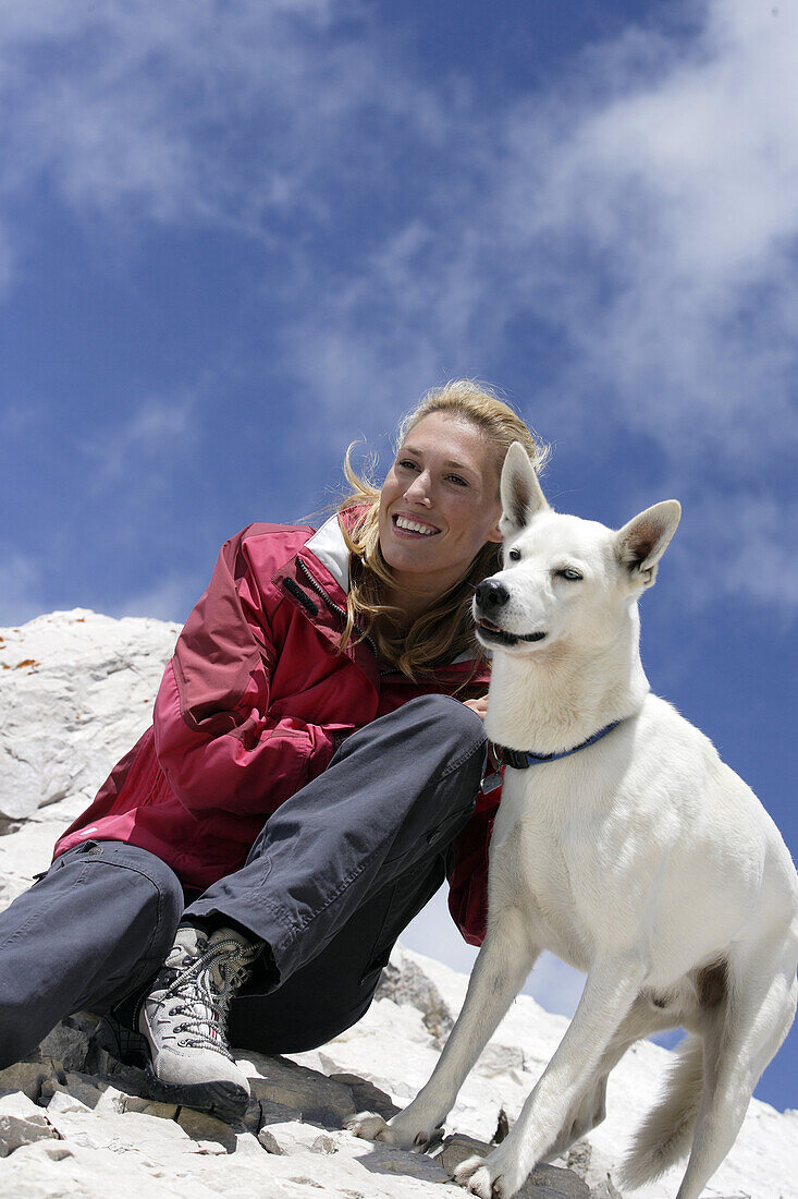 Young woman with dog, mount Zugspitze, Bavaria, Germany