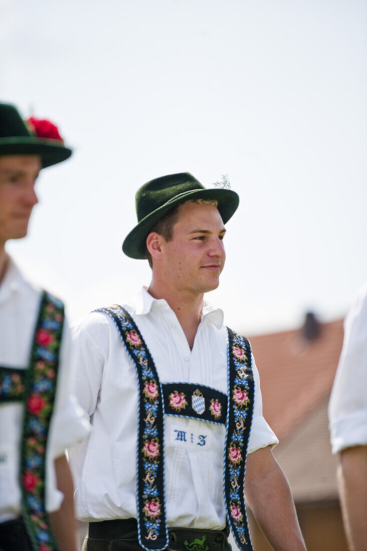 Young men wearing traditional costumes, May Running, Antdorf, Upper Bavaria, Germany