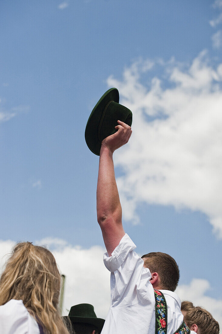 Man holding up a traditional hat, May Running, Antdorf, Upper Bavaria, Germany