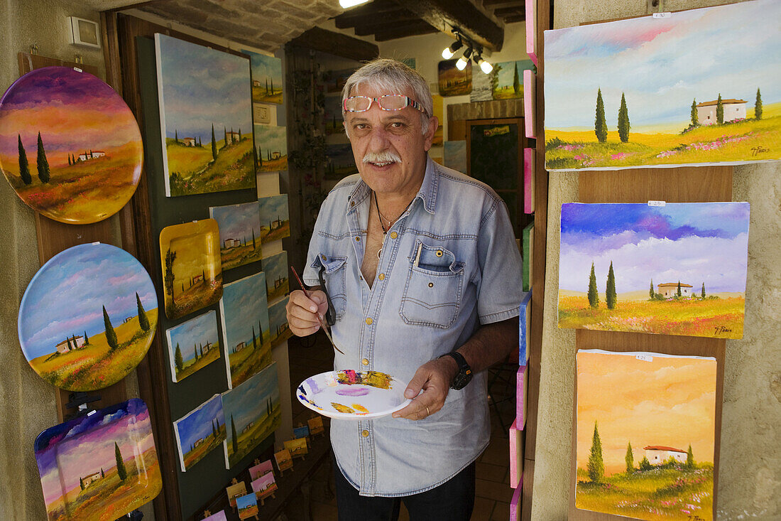 Painter in front of his workshop in Pienza, Tuscany, Italy
