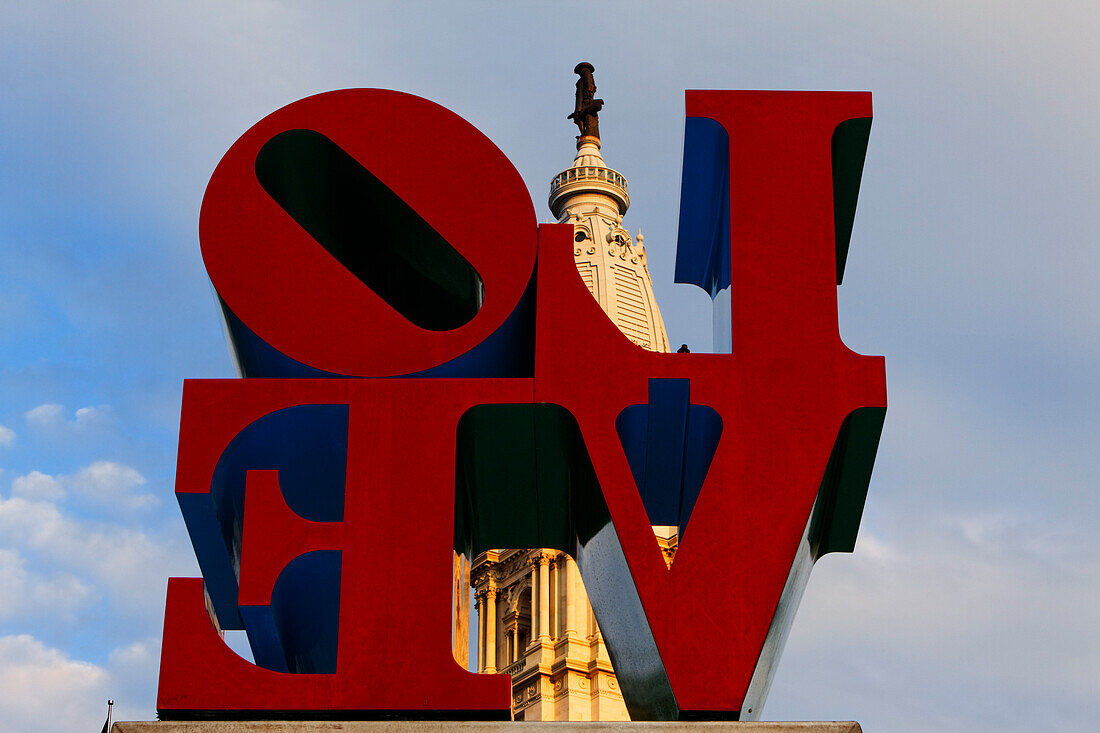 Love sculpture by Robert Indiana in Love Park,with the tower of City Hall in the background, Philadelphia, Pennsylvania, USA