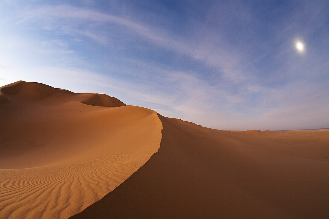 Sanddunes in the libyan desert with moon at dawn, Sahara, Libya, North Africa