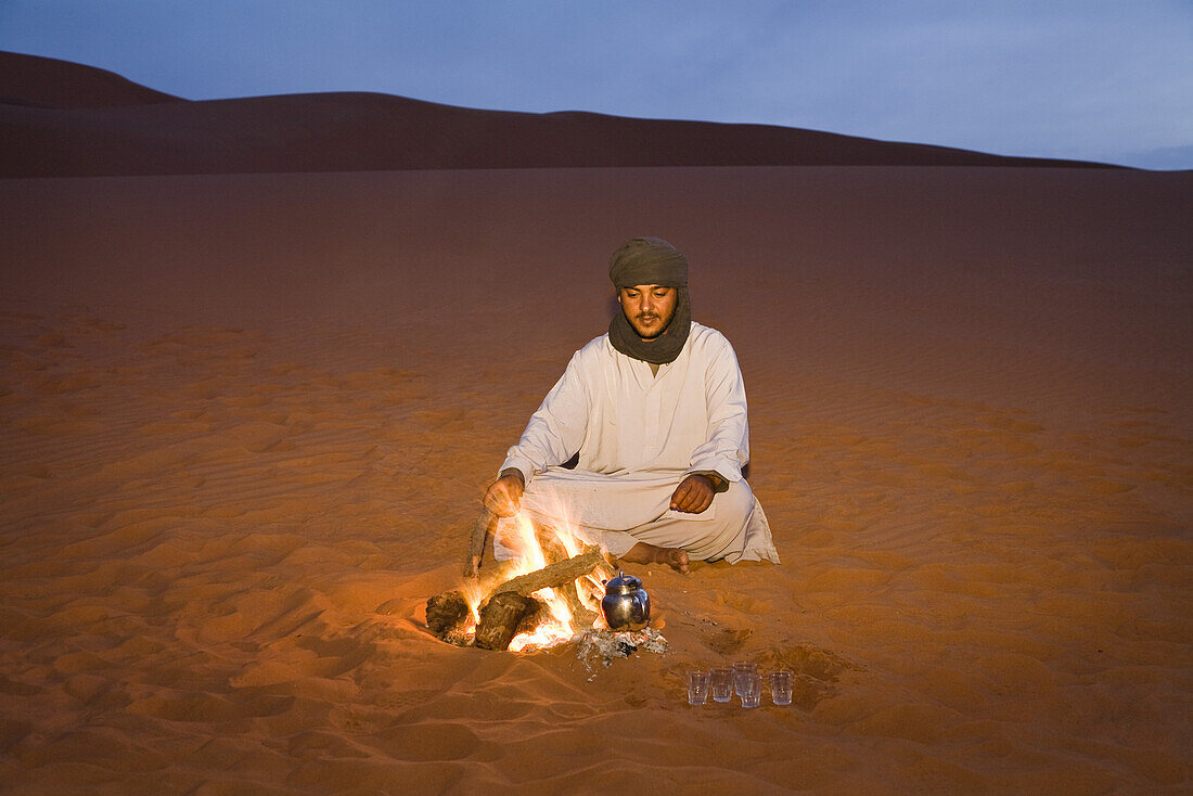 tuareg preparing tea at campfire, Libya, Africa