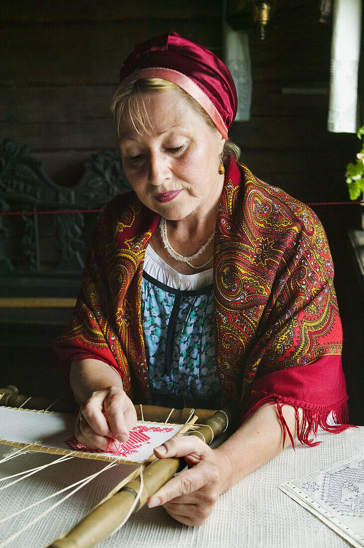 Artisan embroidering in the museum of Russian wooden architecture of Kizhi, Lake Onega, Republic of Karelia, Russia