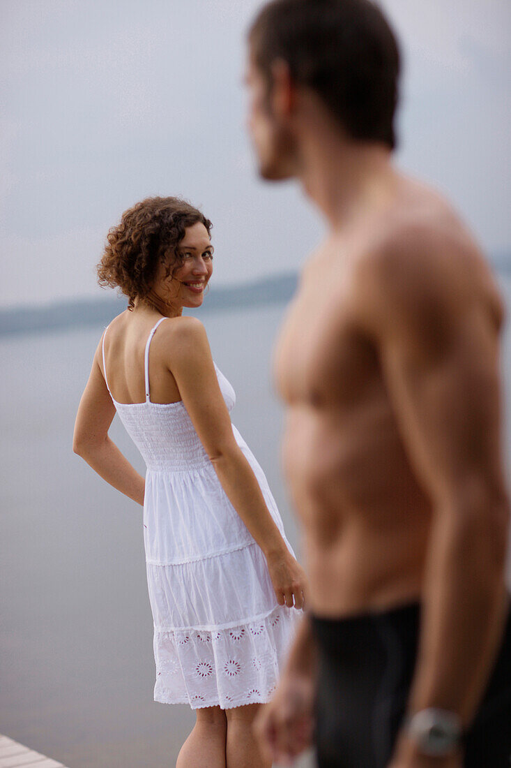 Mid adult woman flirting with a man, Starnberger See, Upper Bavaria, Germany