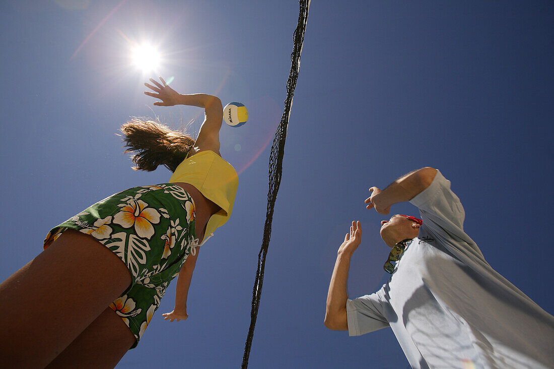 Two people playing beach volleyball, view from below, Mallorca, Balearic Islands, Spain