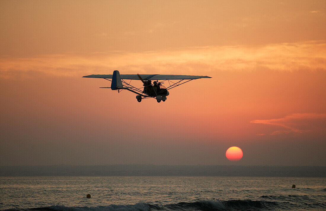 Ultralight plane flying over the beach of Es Trenc, Mallorca, Balearic Islands, Spain
