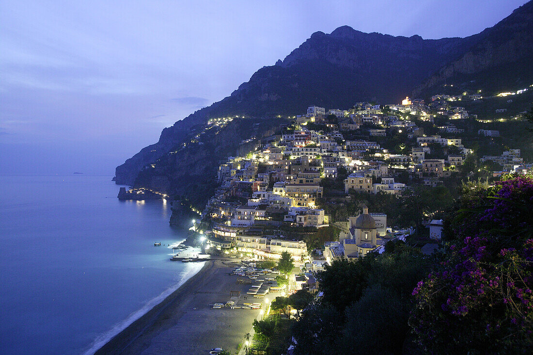 View of Positano with cliffside homes in the evening light, Amalfi Coast, Italy
