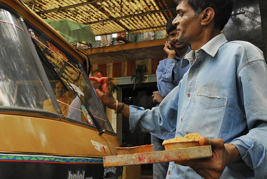 Brahmin blessing motor rickshaw at Bangalore, Karnataka, India, Asia