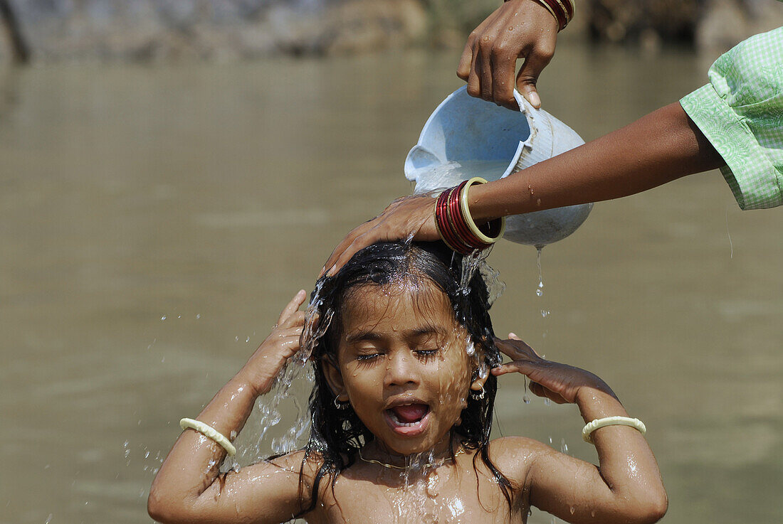 Girl bathing in a river, Bastar, Chhattisgarh, India, Asia