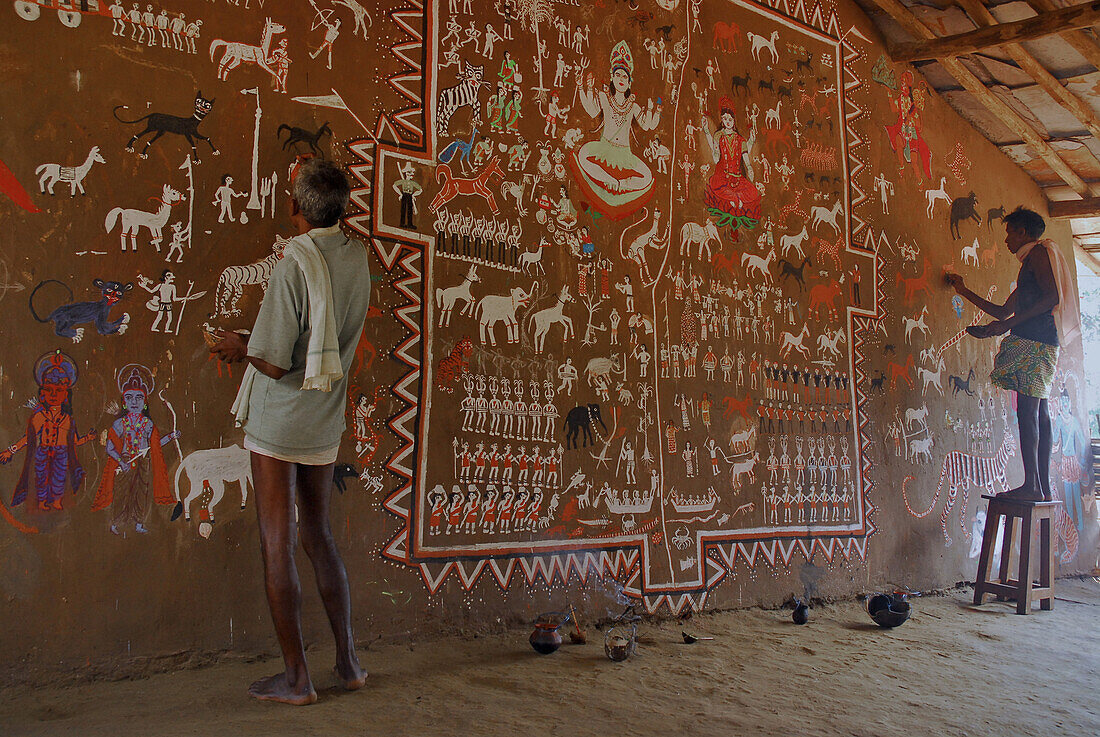 Men painting tribal art on a wall in a ceremonial hall, Bastar, Chhattisgarh, India, Asia