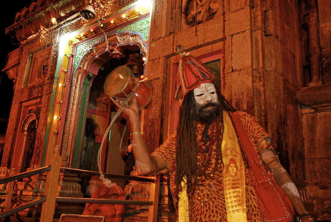 Holy Hindu temple dedicated to Shiva in Kedernath with Sadhu at evening ceremony, Uttarakhand, India, Asia