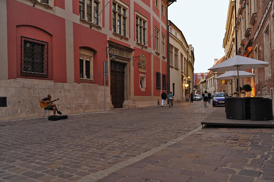 Cobblestone and guitar player at Ulica Kanonicza in the evening, Krakow, Poland, Europe