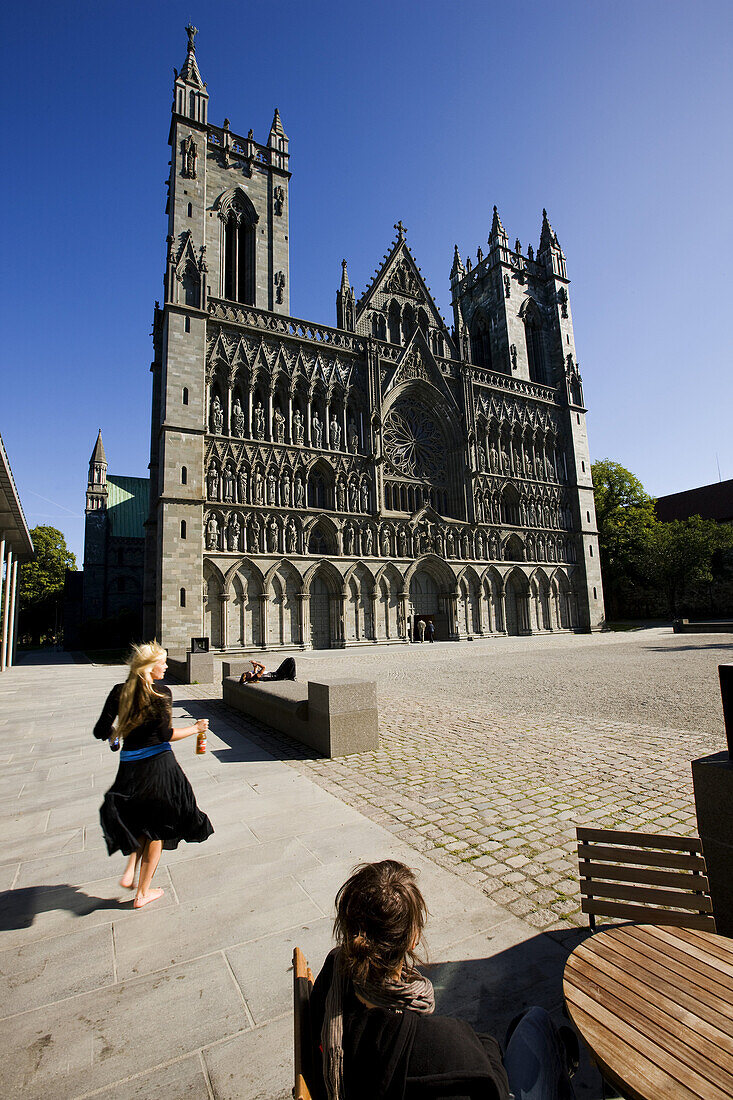 People in front of the Nidarosdomen Cathedral under blue sky, Trondheim, Trondelag, Norway, Scandinavia, Europe