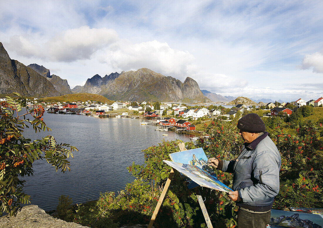 Norwegian painter in front of the coastal village Reine, Lofoten, Norway, Scandinavia, Europe