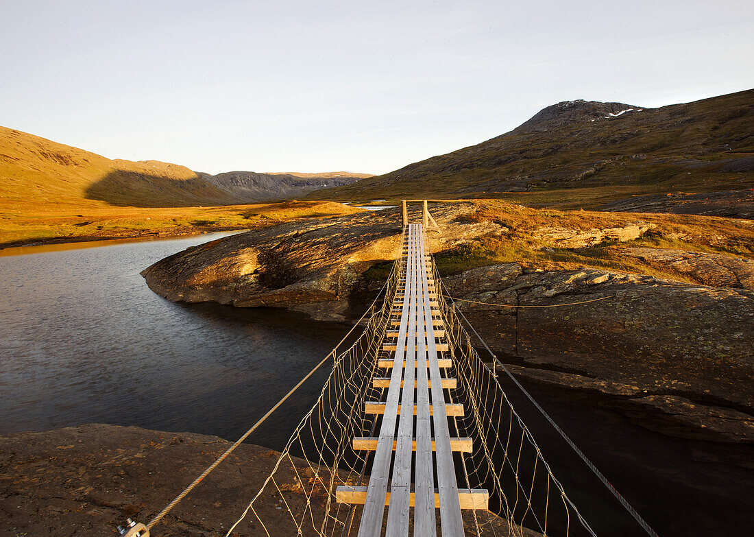 Suspension bridge in the Storengdalen in autumn, Sjurfjellet Saltar, Norway, Scandinavia, Europe