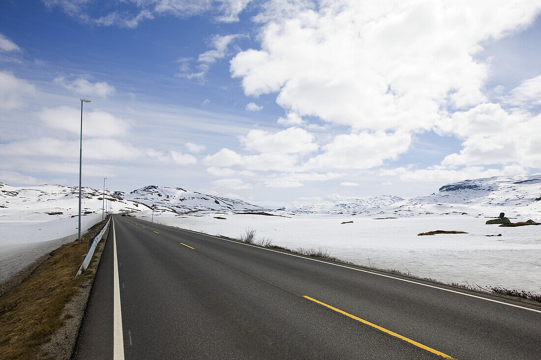 Country road through the snow covered Roldalsfjellet, Hodaland, Norway, Scandinavia, Europe