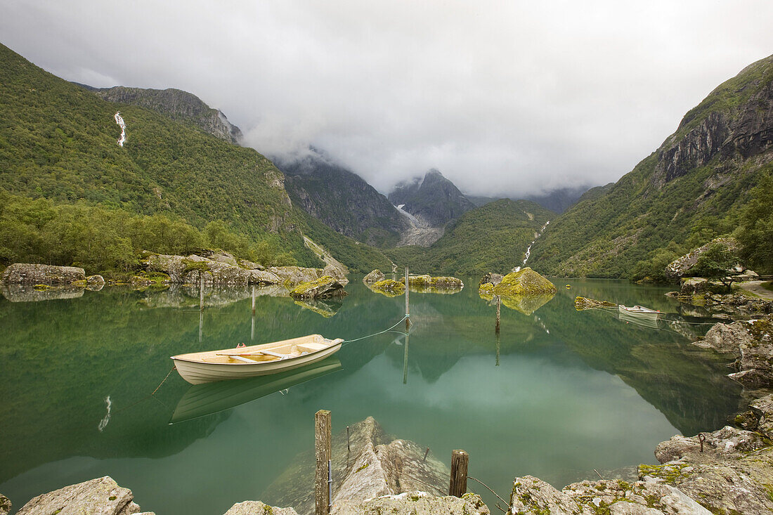 View at the glacier Bonhusbrea with the green sea Bondhusvatnet and boat in the foreground, Sunndal, Folgefonn peninsula, Kvinnherad, Hordaland, Norway, Scandinavia, Europe