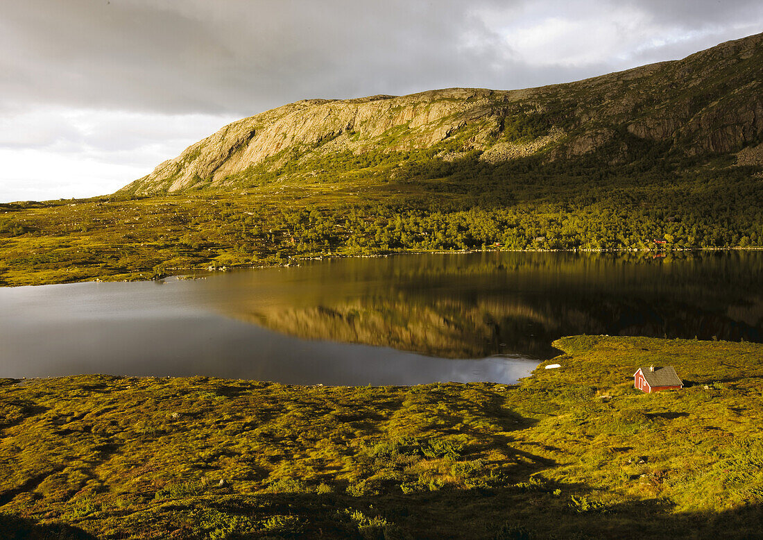 Red wooden house at lake Mannsvatnet at the Solfjellet, Folgefonn peninsula, Kvinnherad, Norway, Scandinavia, Europe