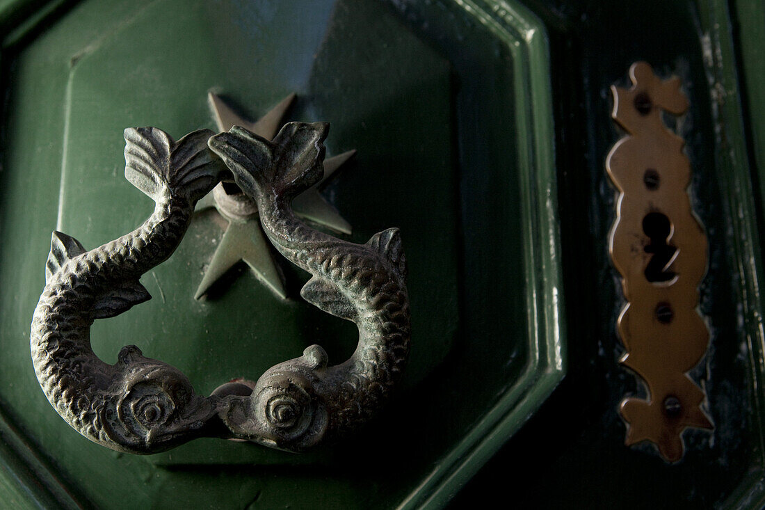 Close-up of a door knocker, dolphins and the Maltese Cross are signs of the knights of Malta, Valletta, Malta, Europe
