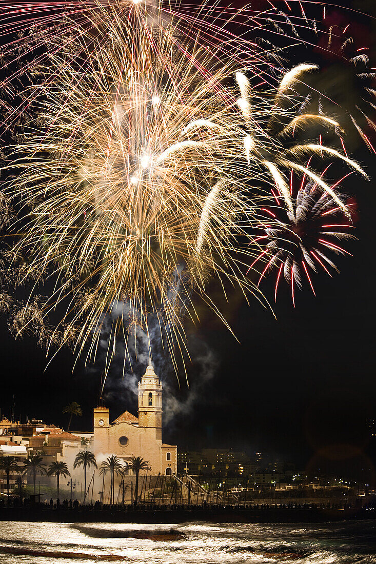 Firework display over Sitges Cathedral La Punta at night, Festival of Santa Tecla, Sitges, Catalonia, Spain, Europe