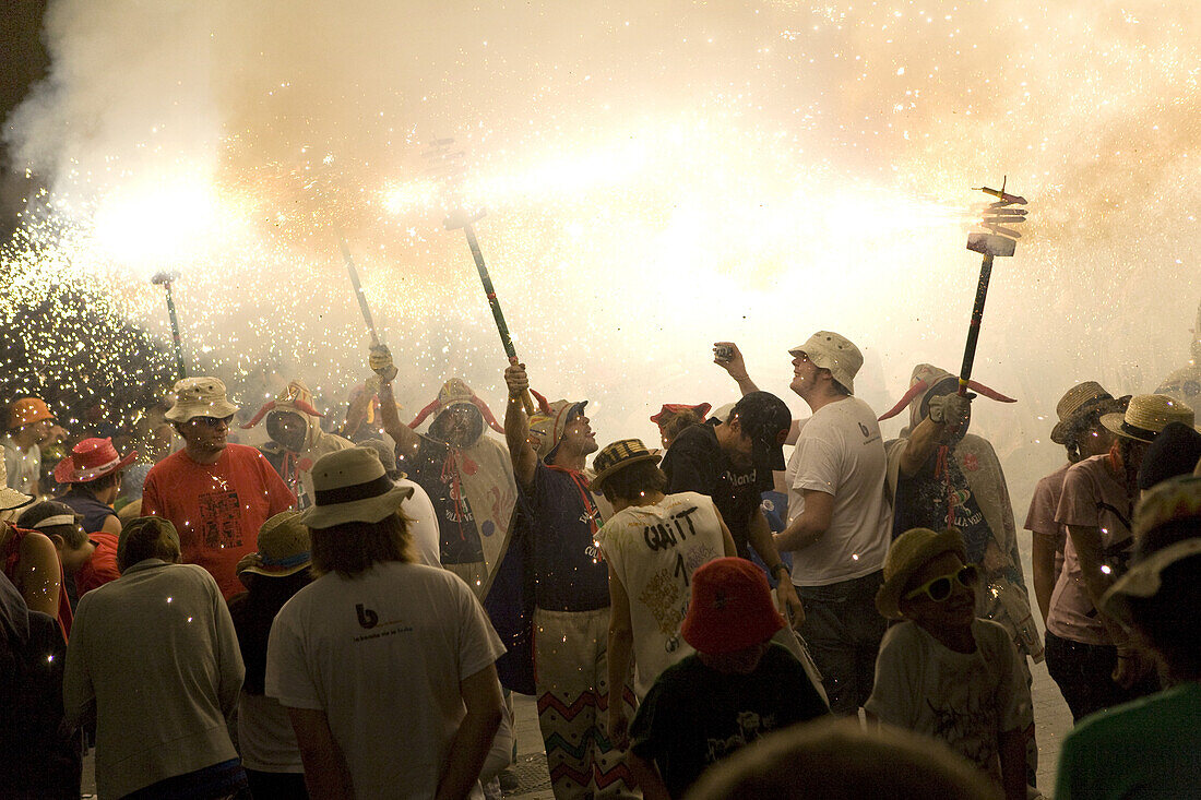 People with firecrackers at the Festival of Santa Tecla, Sitges, Catalonia, Spain, Europe