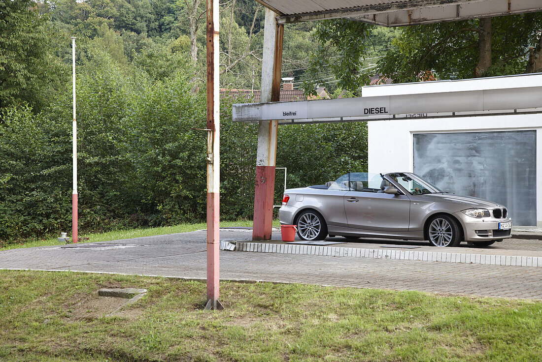 Convertible near closed gas station, Gernsbach, Black Forest, Baden-Wuerttemberg, Germany