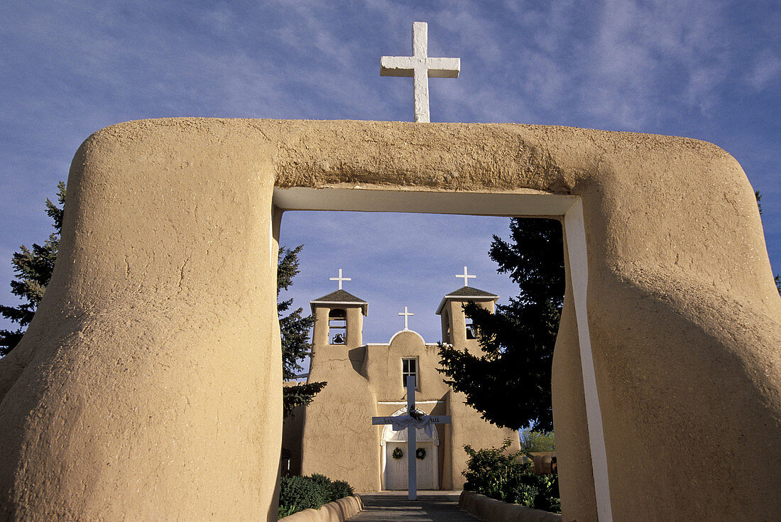 Church Facade With White Crosses Adobe walls buttress bell towers topped with white crosses at the San Francisco de Asis Church  Rancho de Taos, New Mexico  control