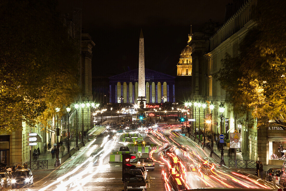 Traffic on Rue Royale from Sainte-Marie Madeleine church in the evening, Paris, France
